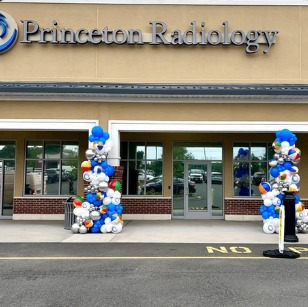Blue and white balloon columns welcoming guests outside a medical office