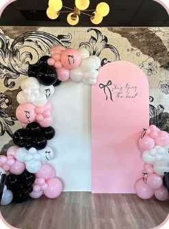 Pink, white and black balloon décor with two arched panels