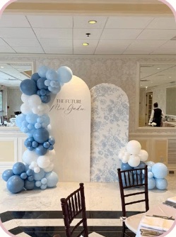 Blue and white balloon garland with a floral double backdrop