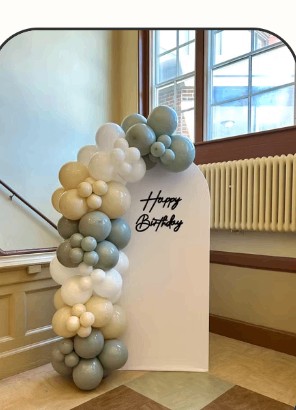 Cream and taupe balloon garland on a happy birthday backdrop