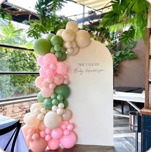 Pink, green and ivory balloons on a white baby shower panel