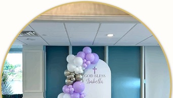 Detail of lavender and white balloons beside a personalized God Bless panel