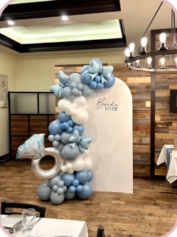 Dusty blue and white balloon garland with ring-shaped accents