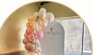 Detail of peach, pink and ivory balloons on a blessing celebration backdrop