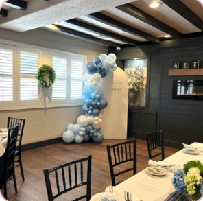 Blue and ivory balloon backdrop in an intimate celebration venue