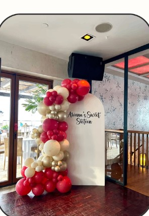 Red, pink and white balloon garland for a sweet sixteen