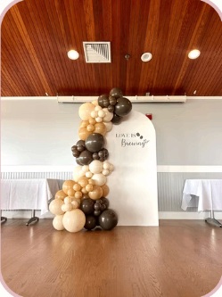 Champagne and chocolate balloon garland with a white panel
