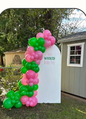 Green and pink balloon arch for a themed birthday party